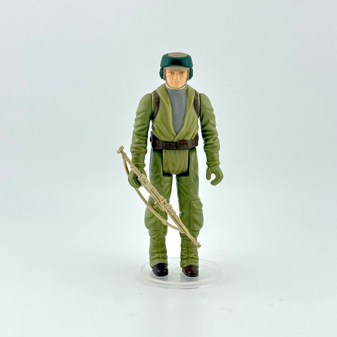 Action figure in green military uniform with a rifle on a white background