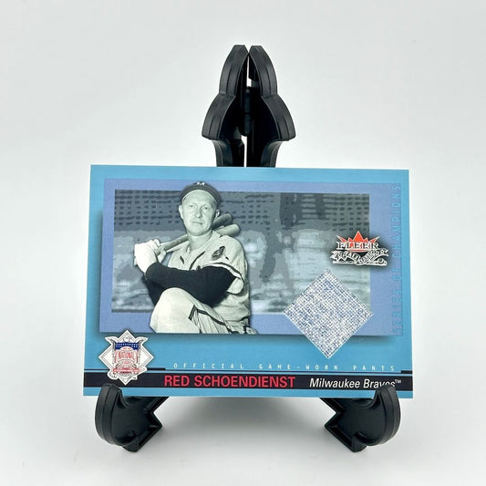 Baseball card of Red Schoendienst held by a black card holder on a white background