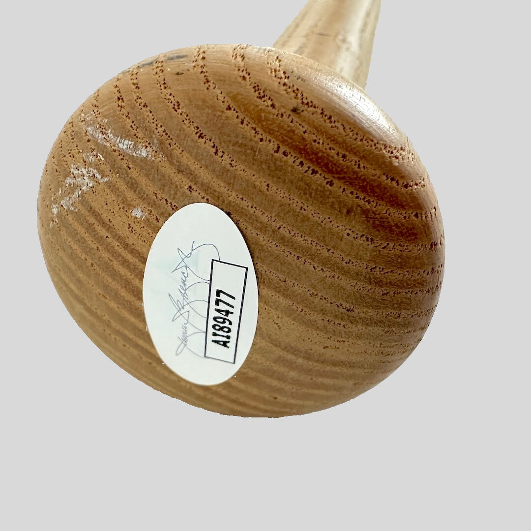 Wooden baseball bat with an authentication label on a white background