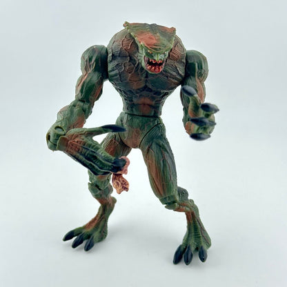 Resident Evil action figure with green and red body and long claws, photographed on white background. 