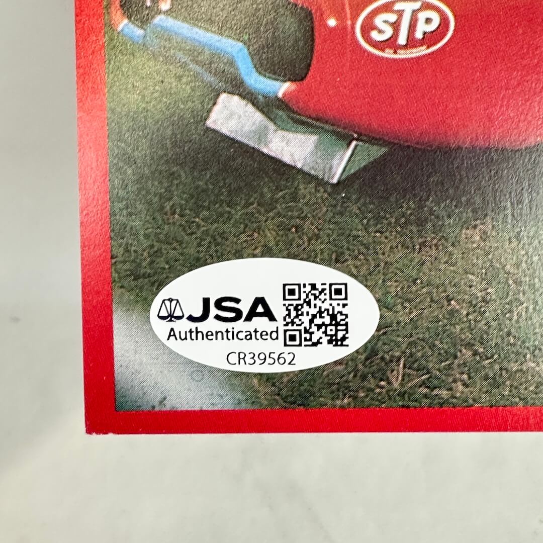 Close-up of a white oval JSA Authenticated sticker in bottom left corner of card. 