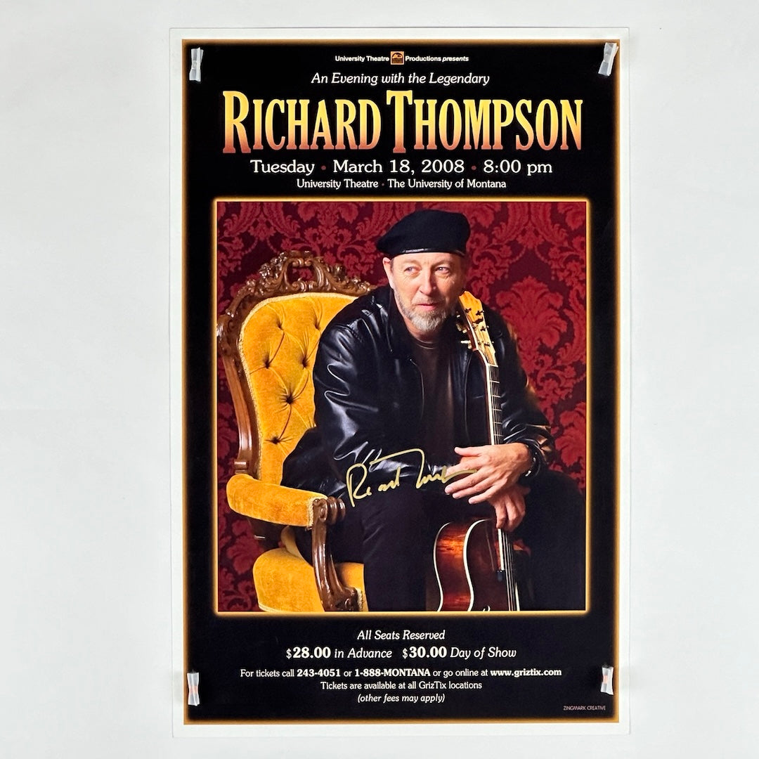 Black background poster with photo of black leather clad Thompson seated in yellow mid century chair in center. 