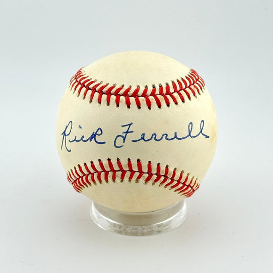Baseball with red stitching and a signature on a white background