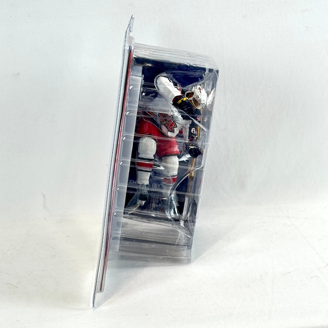 Hockey player action figure in clear packaging on a white background