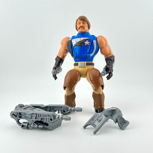 Action figure with blue vest and brown pants on a white background with gray accessories.
