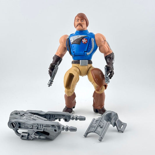 Action figure with blue vest and brown pants on a white background with gray accessories.