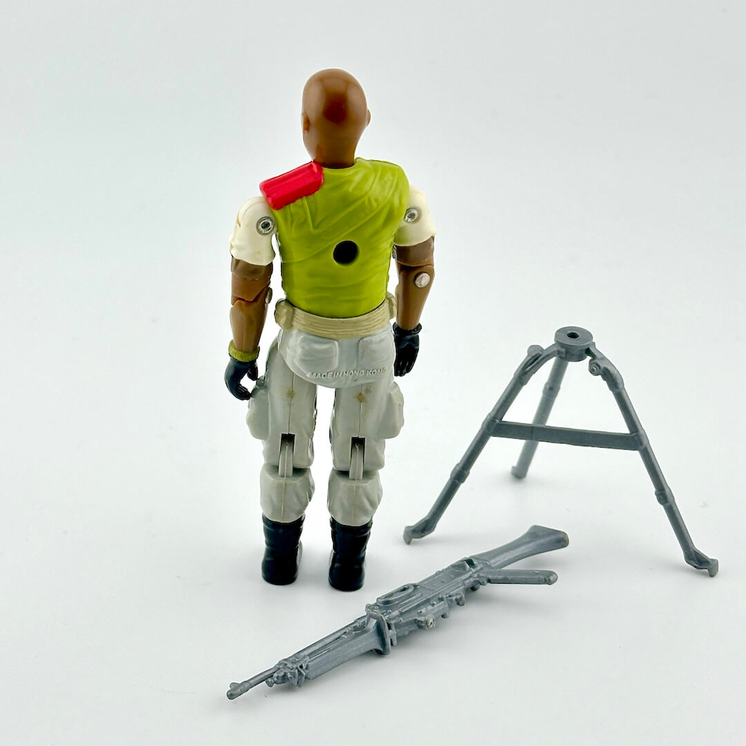 GI Joe action figure with accessories against white background. 