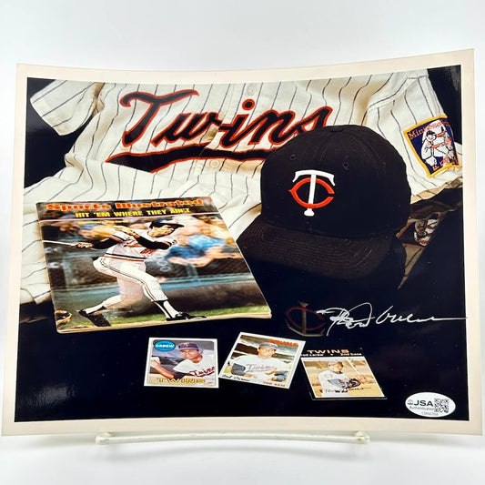Baseball cap and memorabilia with 'Twins' branding on a photo.