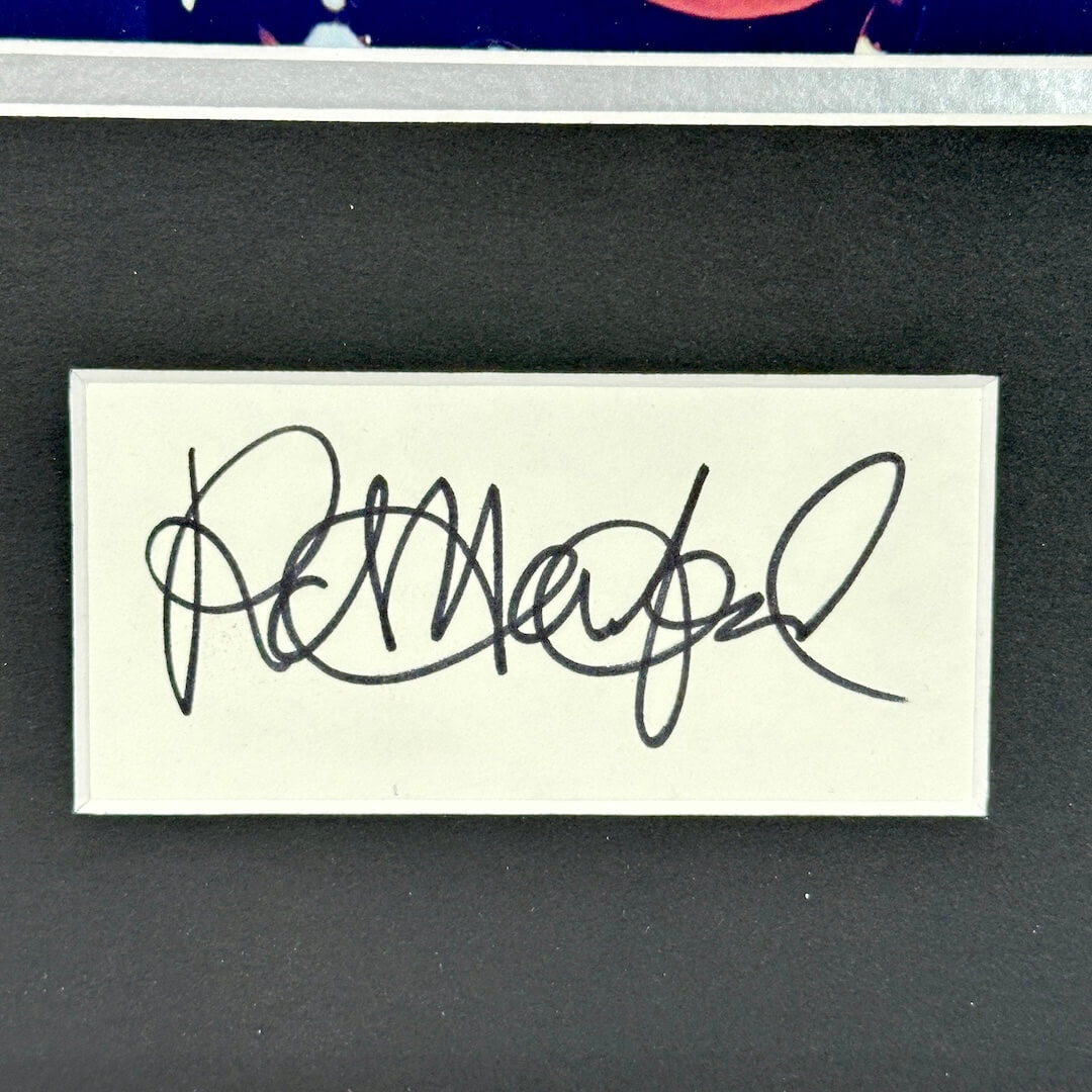 Signature on a small card with a dark background