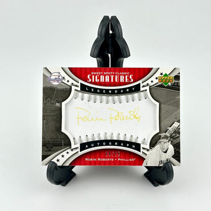 Baseball card packaging with a black stand on a white background