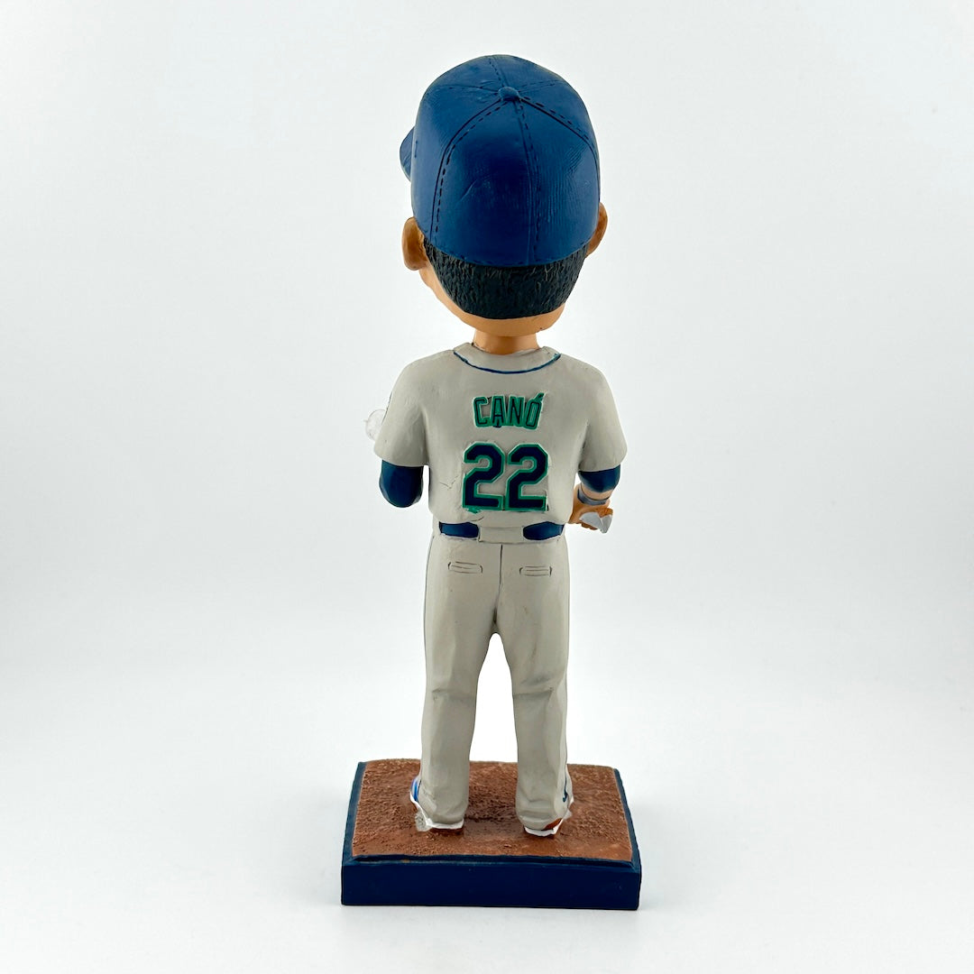 Baseball bobblehead figure with a blue cap and gray uniform on a white background