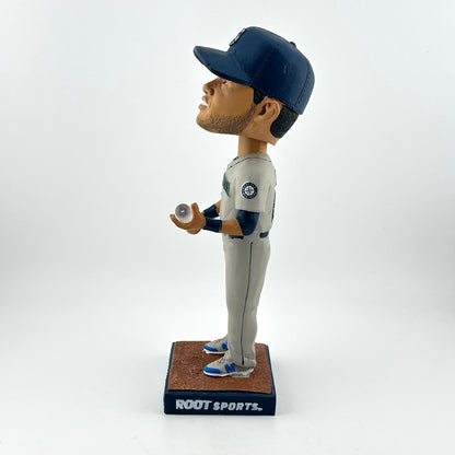 Baseball bobblehead figure in a gray uniform with a blue cap on a white background