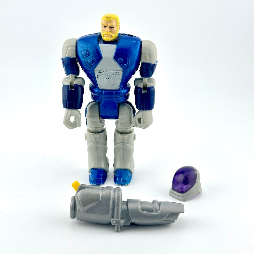 GI Joe action figure in blue and silver armor, pictured with helmet and gun accessory on white background. 
