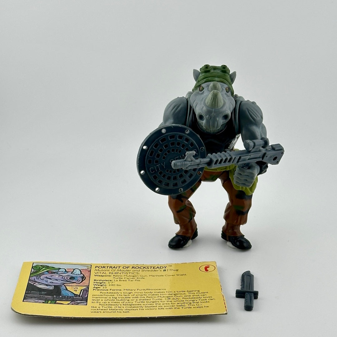 Anthropomorphized Rhino with in brown outfit, grey trash can lid shield, grey gun, and grey knife. With ID card. Front.