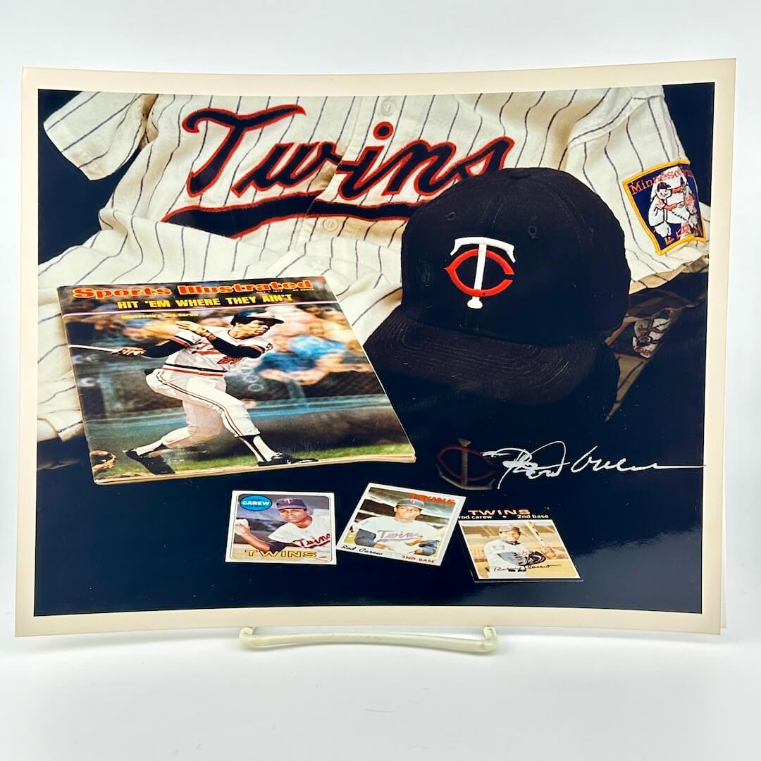 Photo of arranged baseball memorabilia featuring Rod Carew and his signature. 