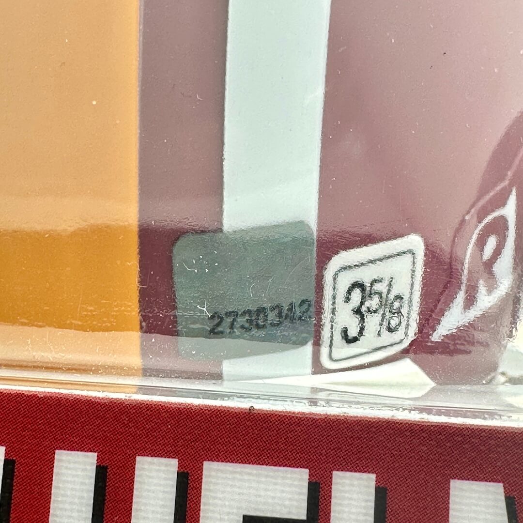 Close-up of a product packaging with a label and barcodes.