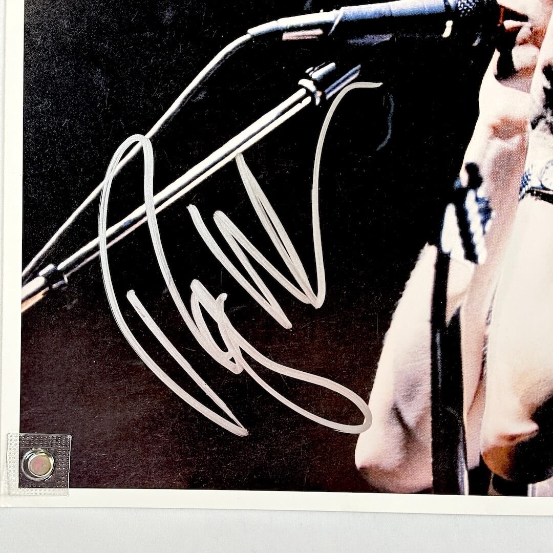 Close up of silver marker signature in bottom left section of photo. 