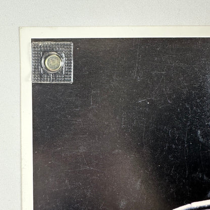 Top left corner of photo showing good condition of edges and corner. Light scratches to photo.