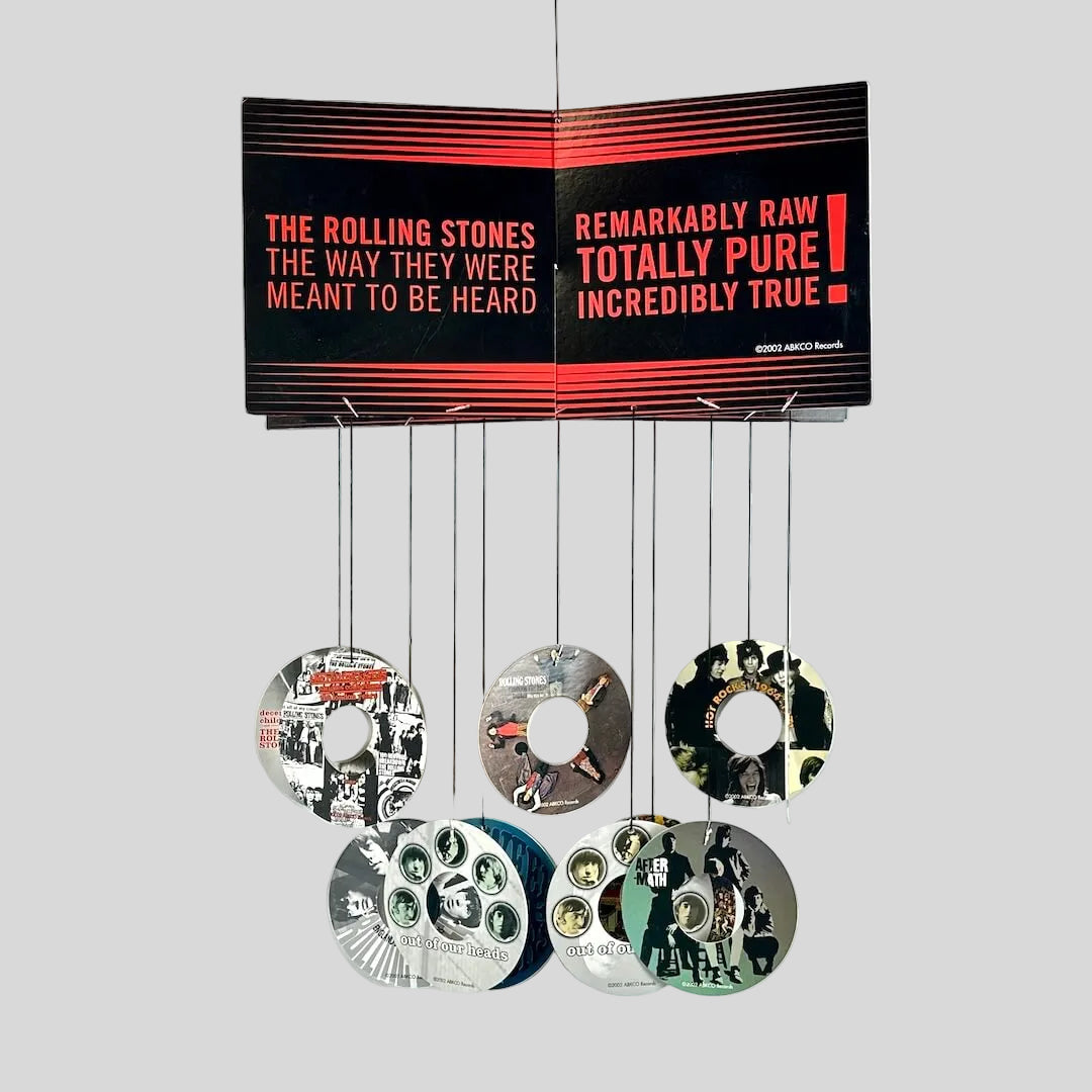 Music album cover with discography on a white background