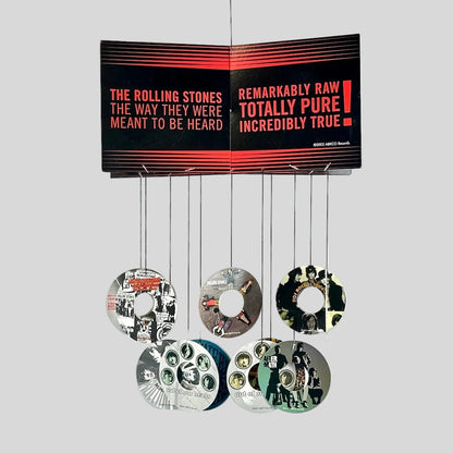 Music album cover with discography on a white background