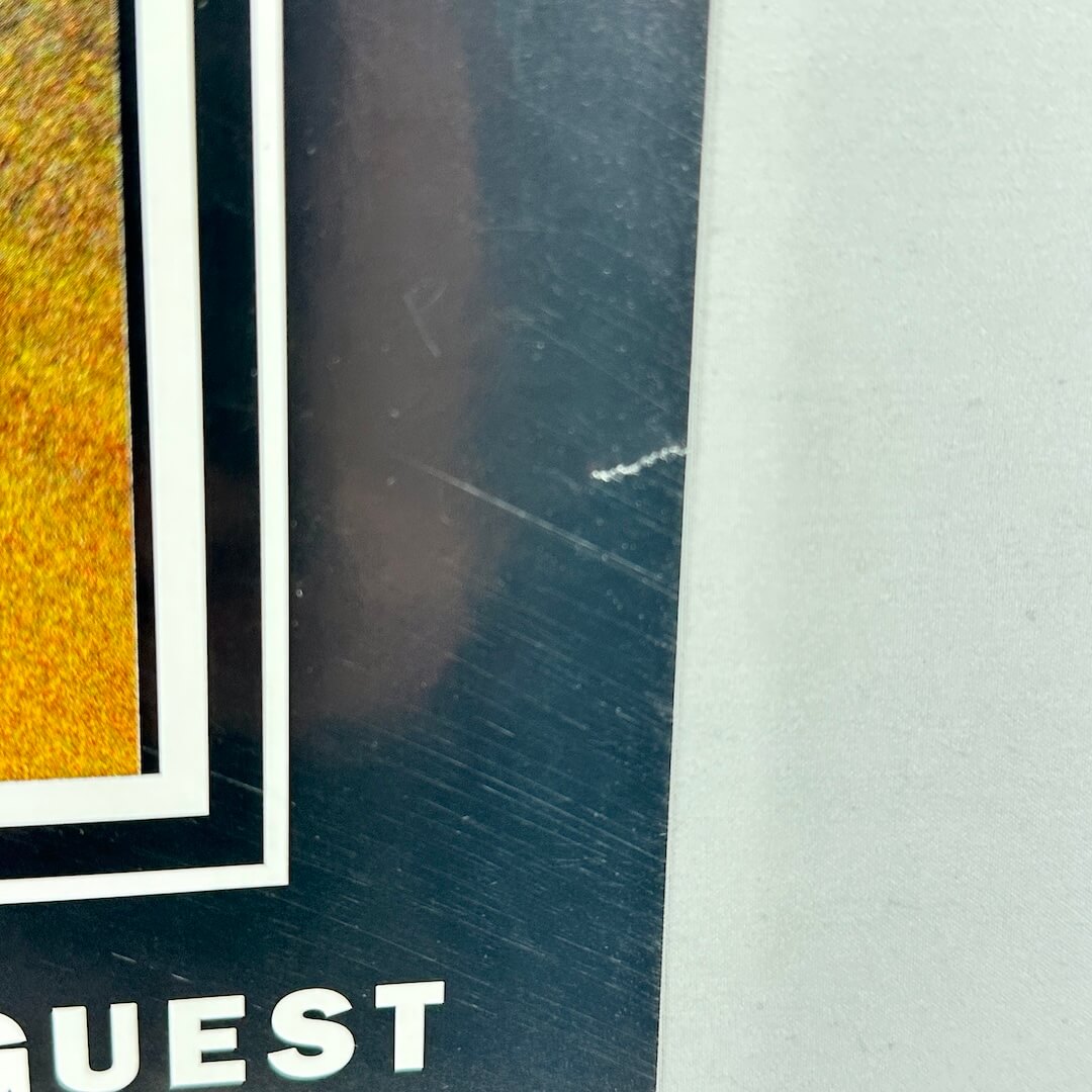 Close-up of tear to lower right edge and some scratches. 