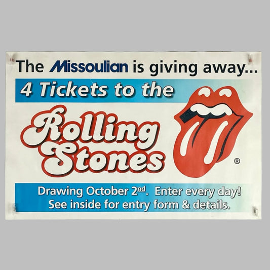 White poster with blue banners with contest info in white text at top & bottom around red Rolling Stones & their logo.