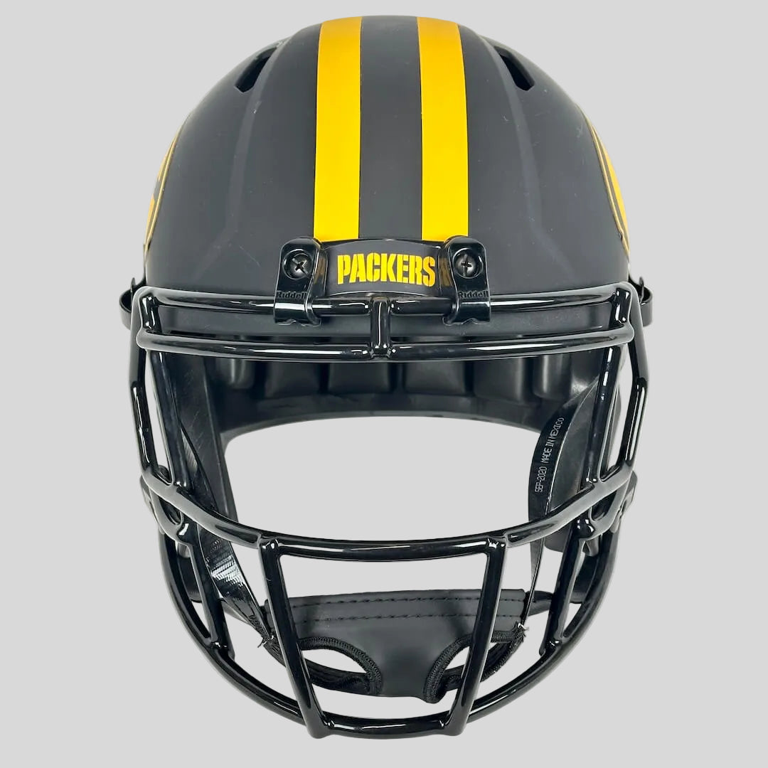 A black and gray football helmet with two yellow stripes, a black faceguard, and a yellow 'PACKERS' patch on the forehead.