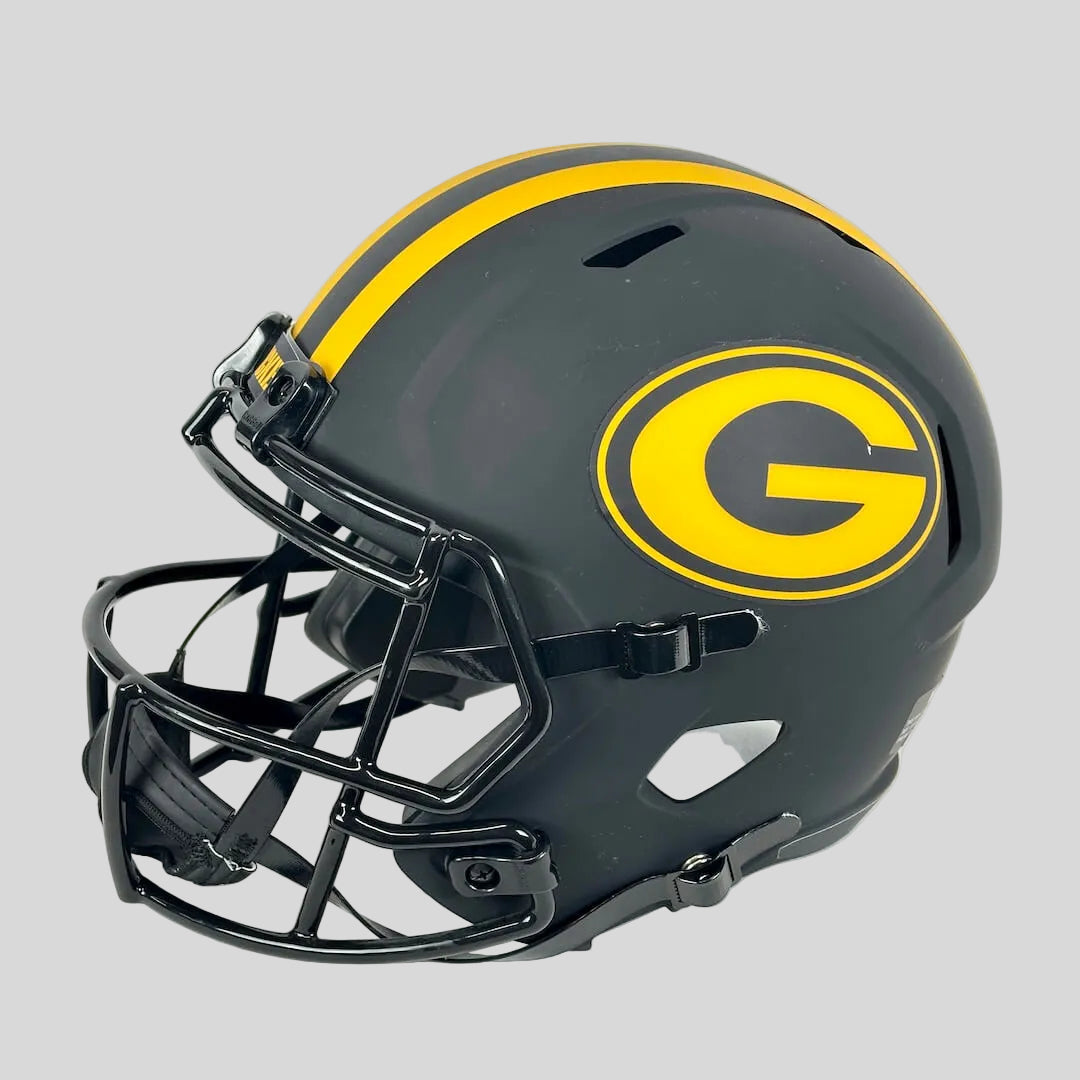 A matte black football helmet with a large yellow and black 'G' logo on the side, featuring a black faceguard.