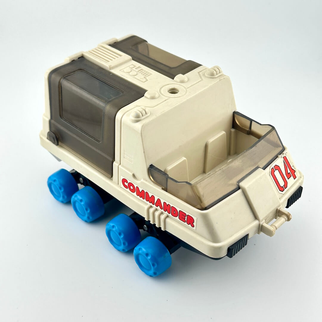 Toy moon rover with blue wheels against white background. 