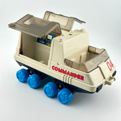 Toy moon rover with blue wheels against white background. 