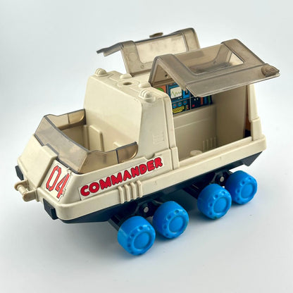 Toy moon rover with blue wheels against white background. 