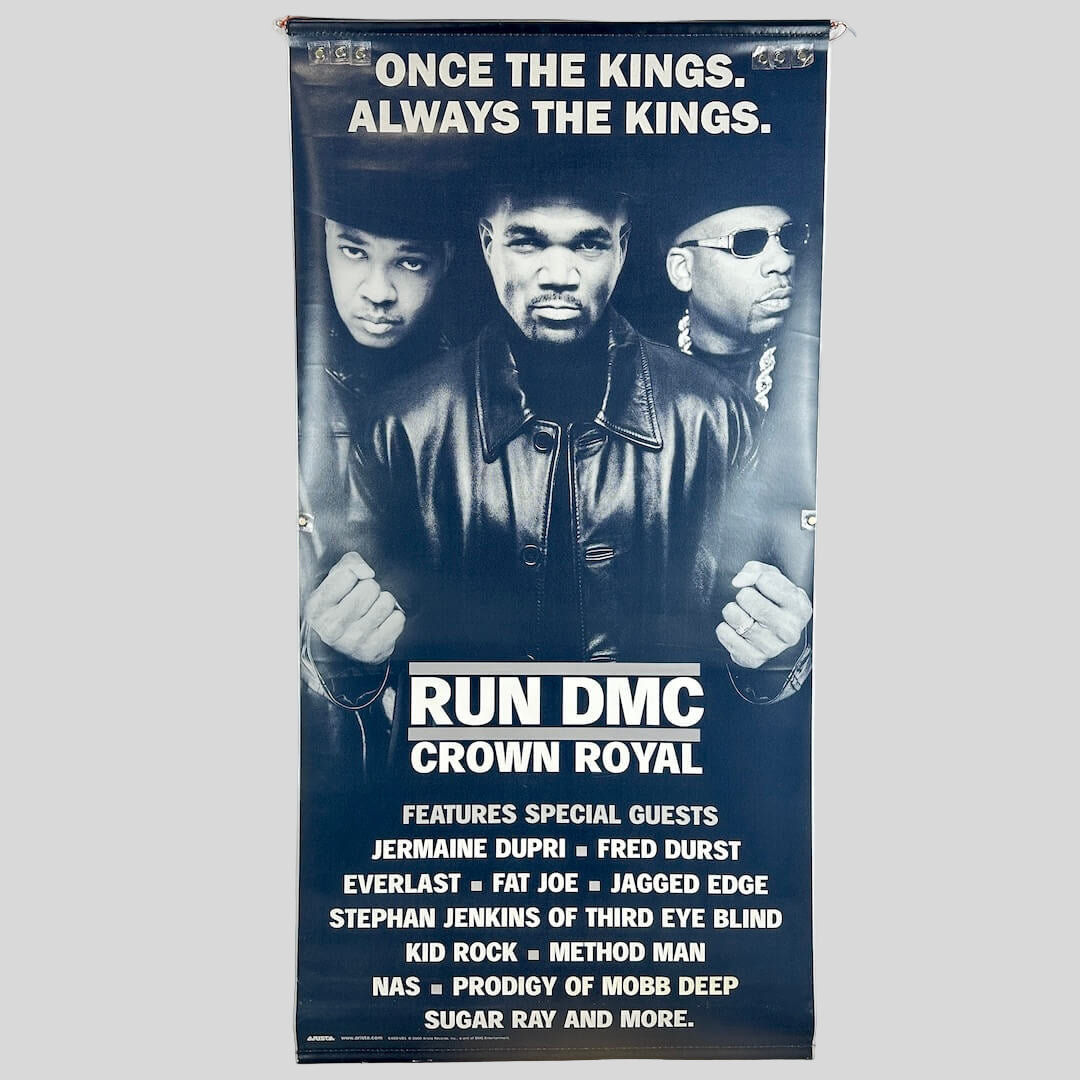 Backside of banner with same image as front, three men in black and white with text at top and bottom of banner.