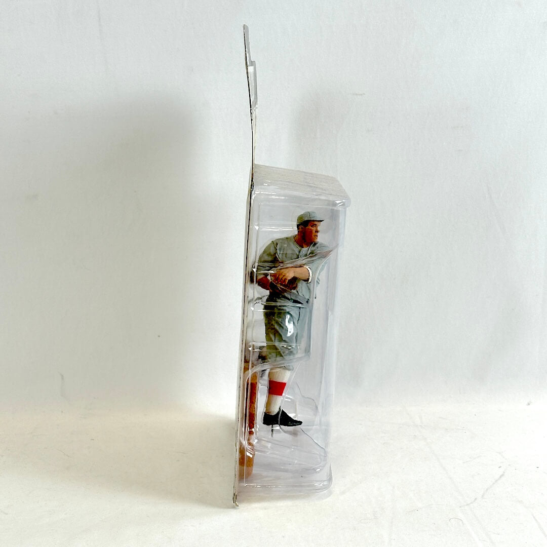 Baseball player figure in a clear plastic packaging on a white background