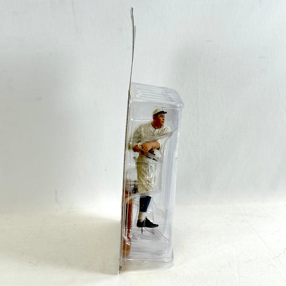 Baseball player figurine in a clear plastic packaging on a white background