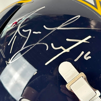 Close-up of a helmet with a signature and number on a reflective surface