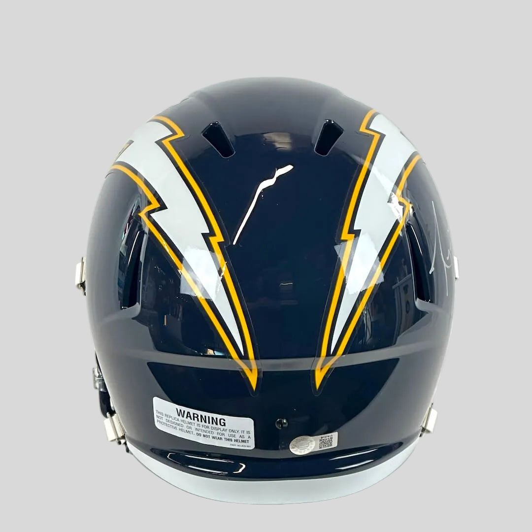 Navy helmet with yellow and white design on a gray background