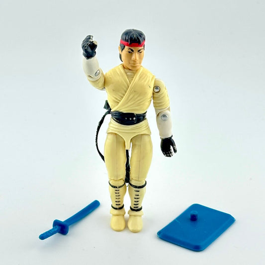 Action figure in martial arts costume with accessories against white background. 