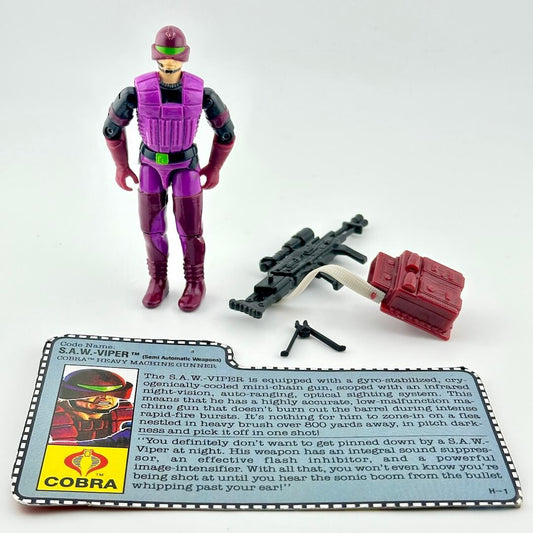 GI Joe action figure with accessories and character card against white background. 