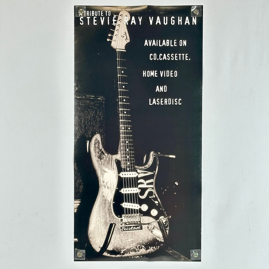 Backside of poster featuring guitar and advertising information. 