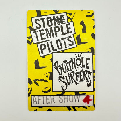 Rectangular backstage pass with yellow background and black printed pattern, logos for bands in white squares. 