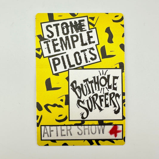 Rectangular backstage pass with yellow background and black printed pattern, logos for bands in white squares. 