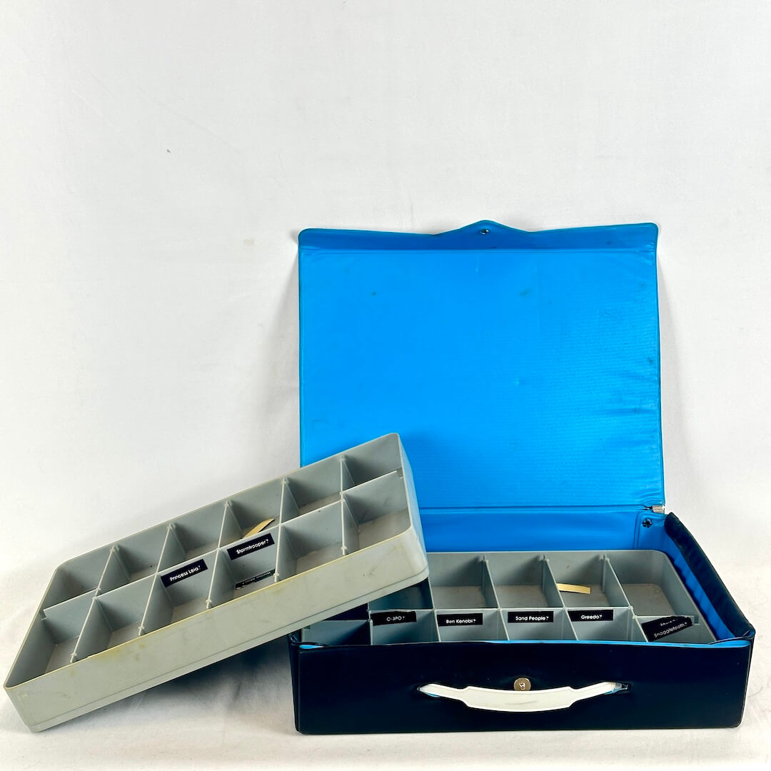 Blue action figure box with a gray interior tray on a white background