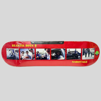 A red skateboard deck featuring a collage of five photos from the band Beastie Boys.