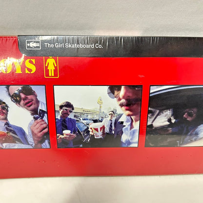 Skateboard deck wrapped in plastic with images of The Beastie Boys and Girl Skateboard Co. logo. 