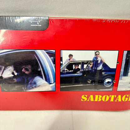 Skateboard deck wrapped in plastic with images of The Beastie Boys and Girl Skateboard Co. logo. 