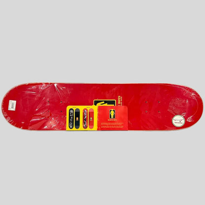 A red skateboard deck shown from the underside, still wrapped in protective plastic, with a yellow and red retail card. 