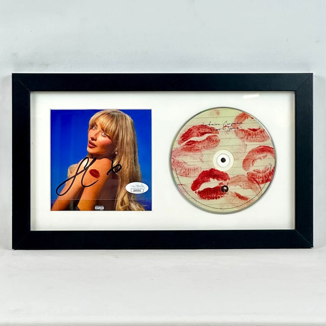 Framed CD insert with a signature and a CD with lipstick prints.