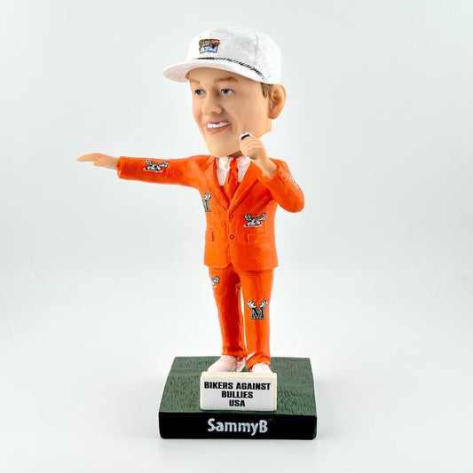 Bobblehead figure in orange suit and white cap on a gray background
