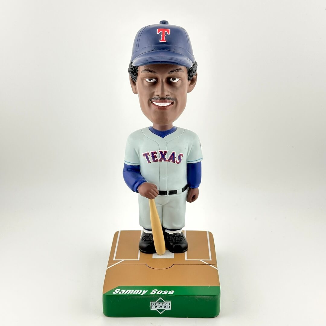 Bobblehead of a baseball player in Texas uniform with a bat on a white background