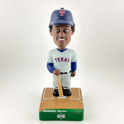 Bobblehead of a baseball player in Texas uniform with a bat on a white background